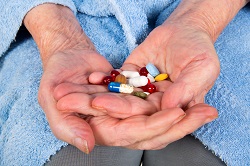 Mix of pills in the hands of a senior